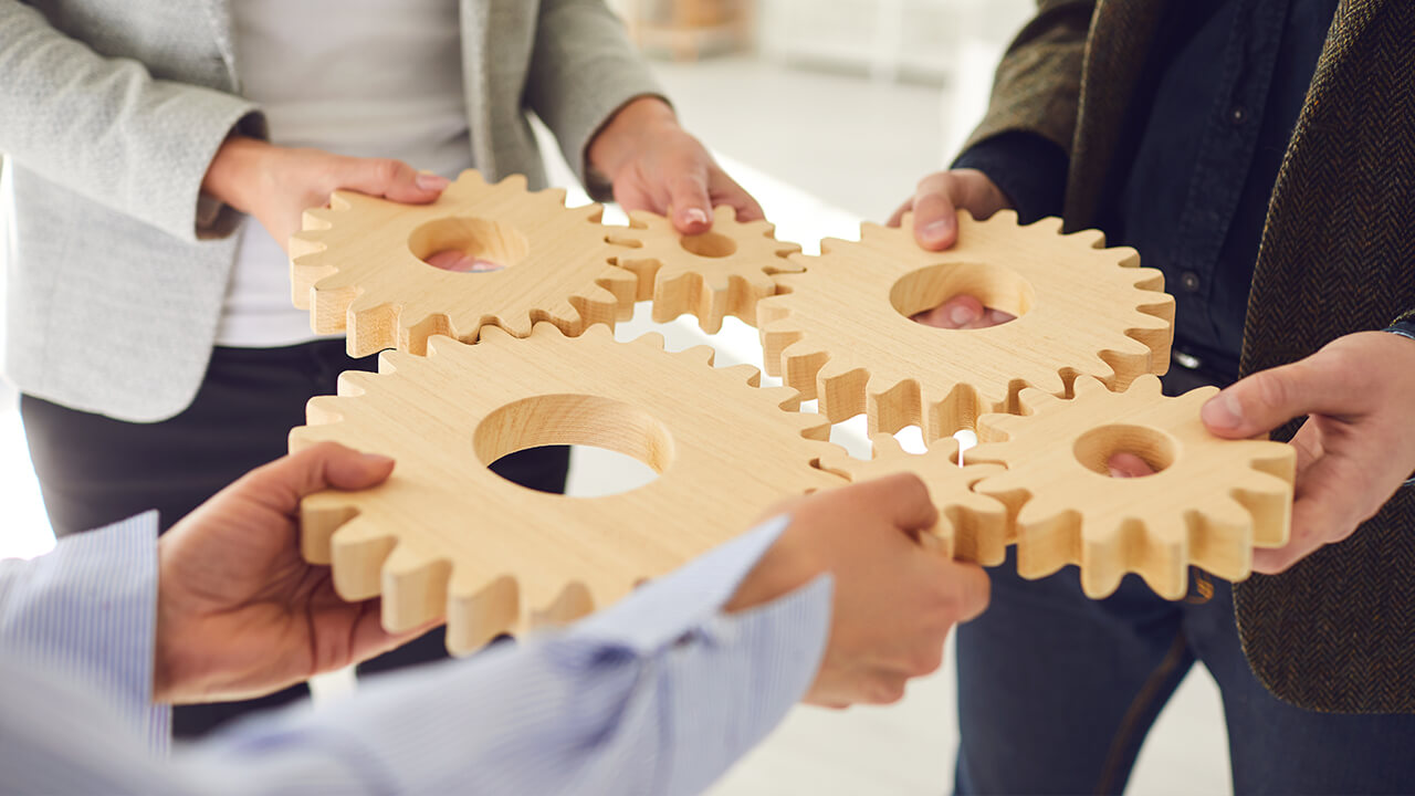 Integration teamwork, people holding cogs, Cogs connected 